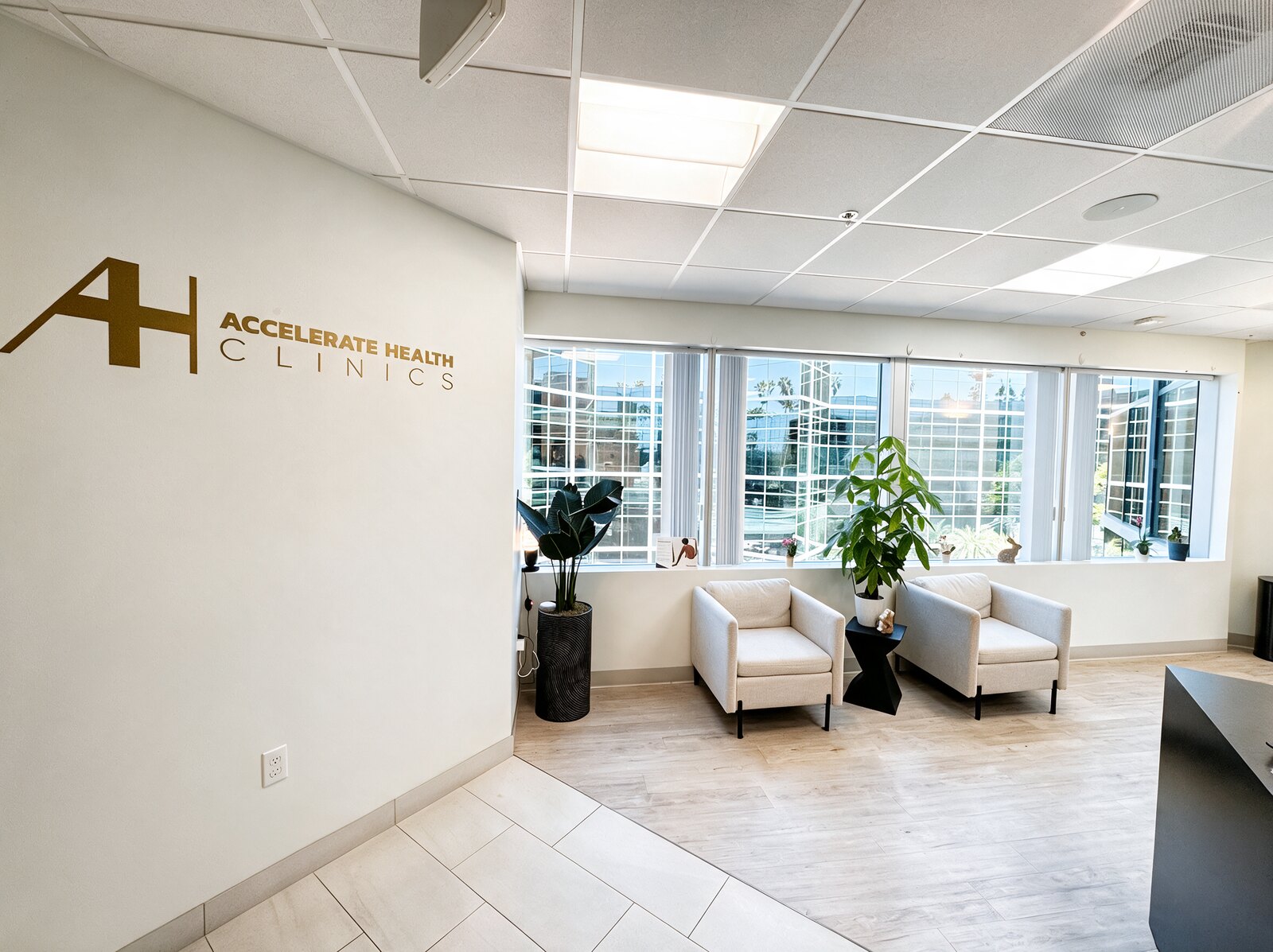 Waiting area at AH Clinics, with the Accelerate Health Clinics sign on the wall