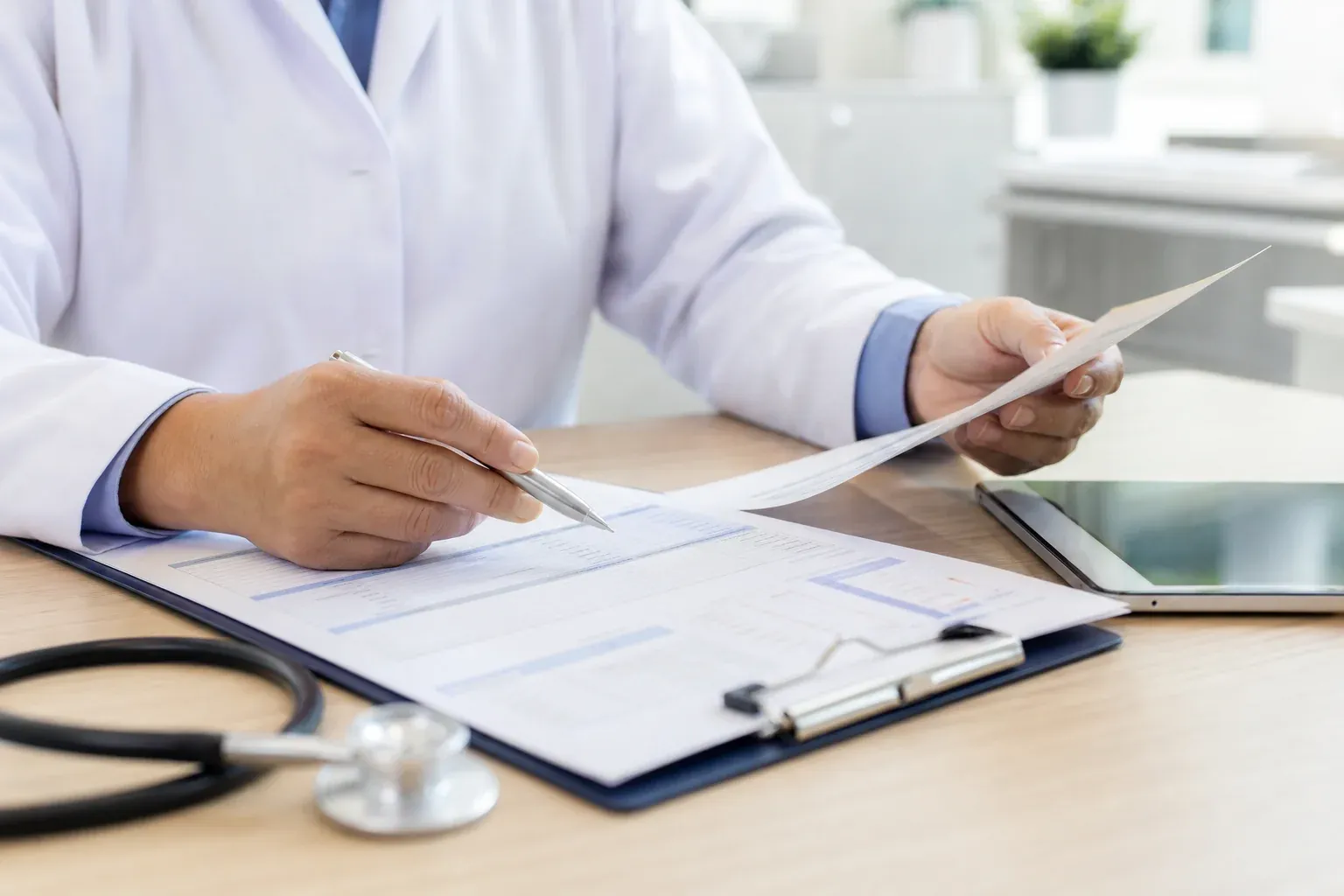 Medical provider reviewing a patient's health history chart during a weight loss consultation