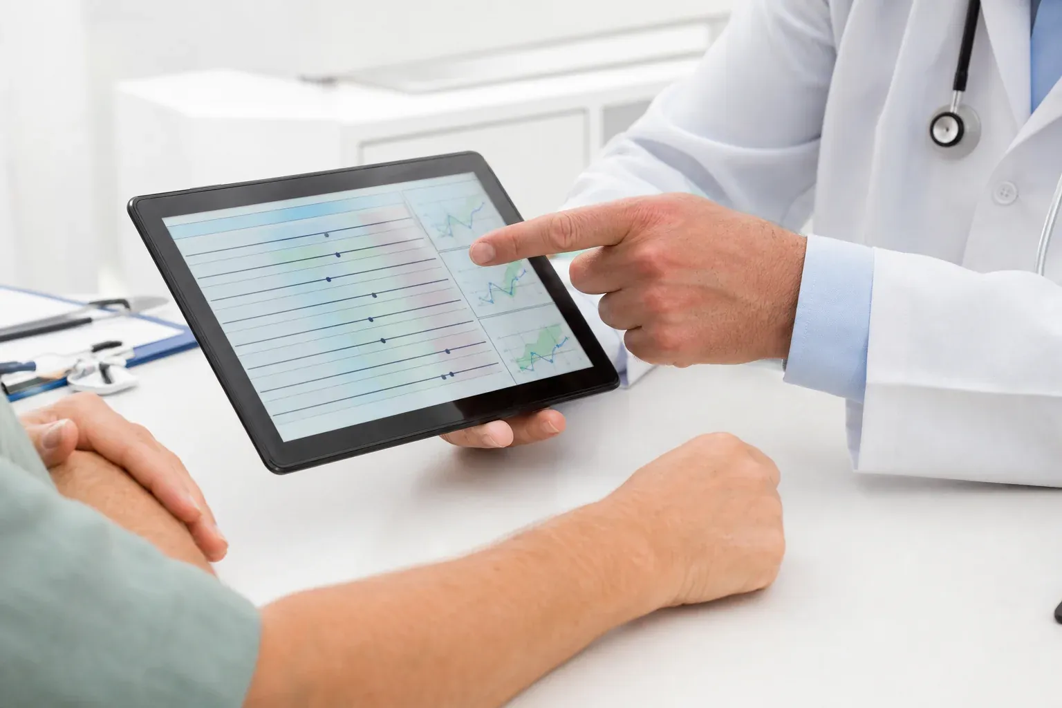 A medical professional reviewing hormone lab results with a patient in a clean, modern clinic consultation room