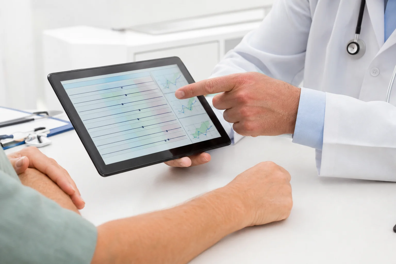 A medical professional reviewing hormone lab results with a patient in a clean, modern clinic consultation room